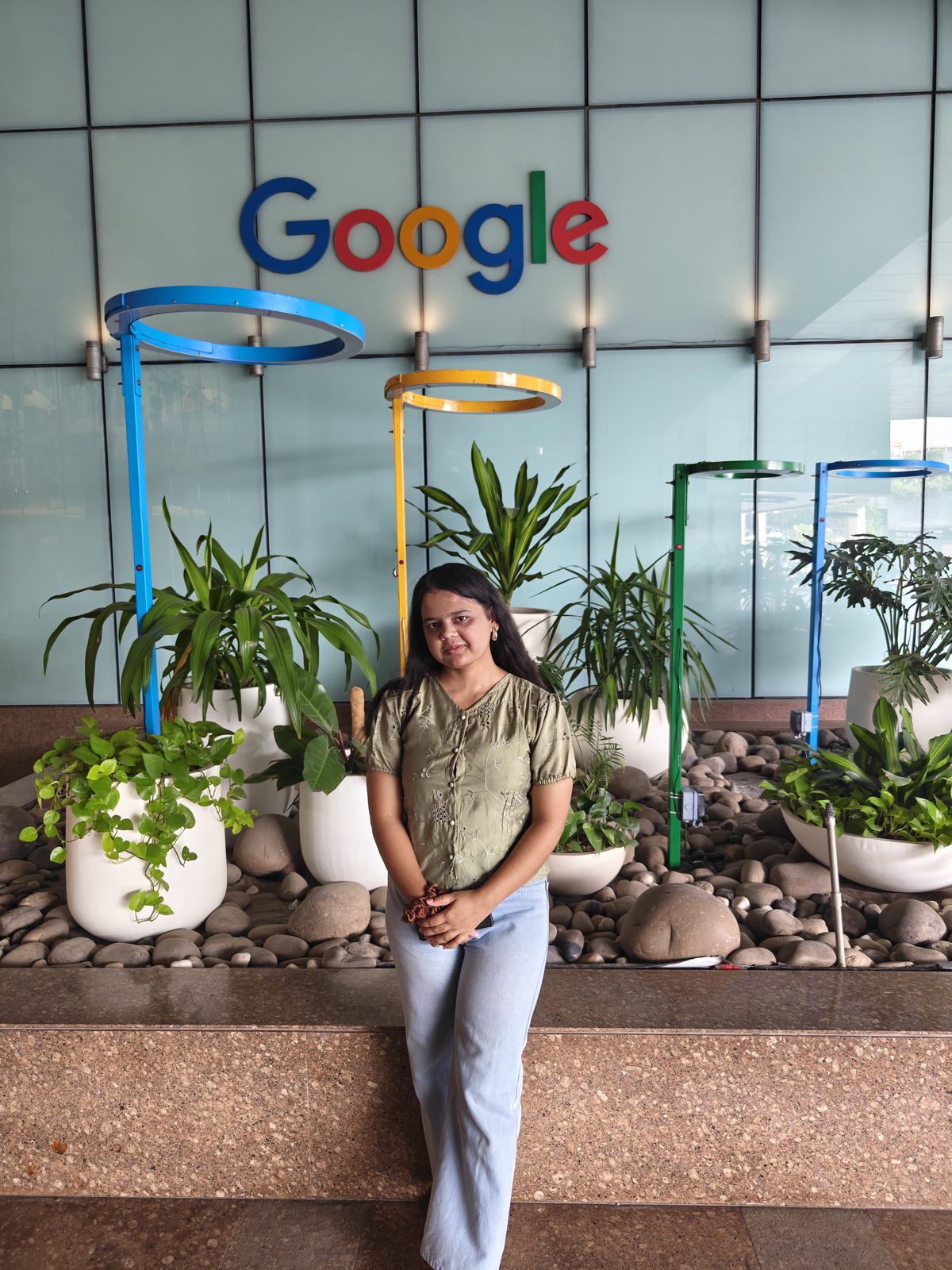 Divya at the Google office in Hyderabad, with the Google logo visible